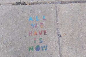 All we have is now stencil on sidwalk